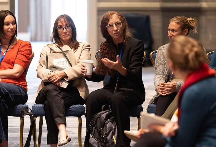 AMWA Members engaged in networking discussion at meeting showcasing Excellence-in-Medical-Communication